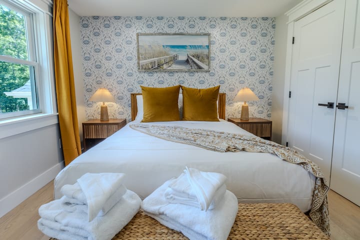 Second bedroom offers a queen bed, smart tv, and front lawn views equipped with blackout curtains