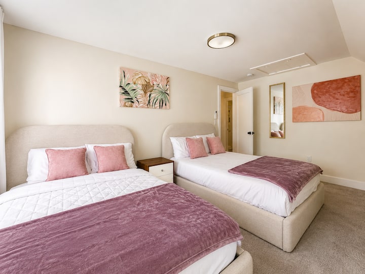 Comfortable bedroom with two beds and soft, welcoming finishes.