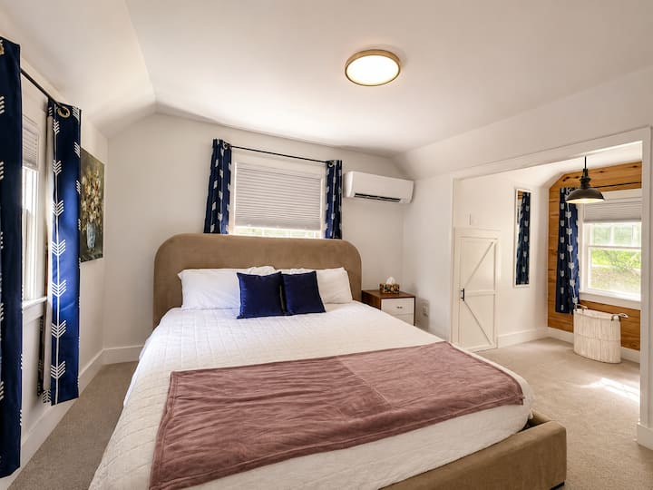 Comfortable private bedroom with air conditioning and a bright window nook.
