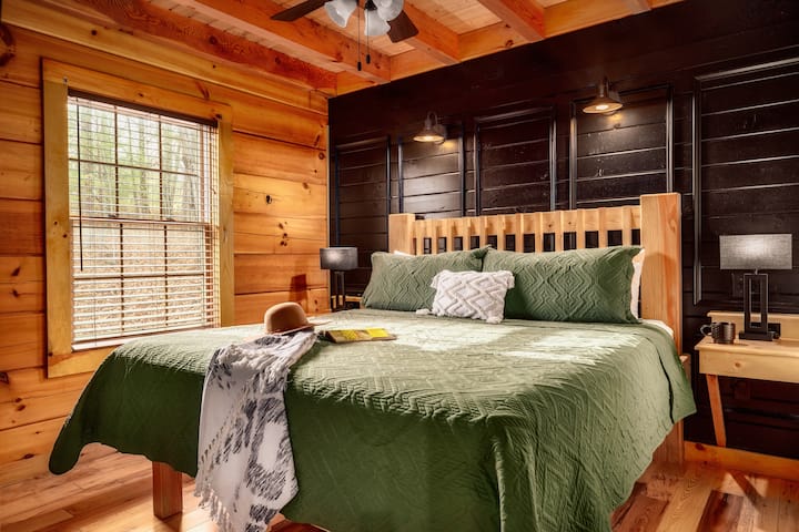 Comfortable king bedroom featuring rustic wood details and serene surroundings.