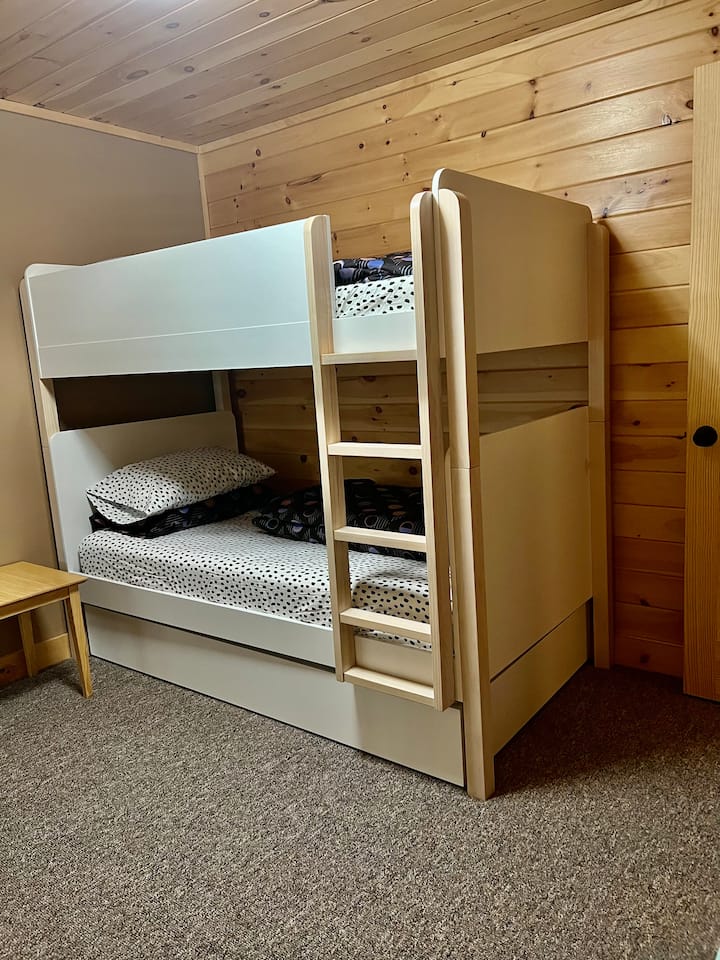 Bedroom 3 is equipped for 3 kids. The bunk includes 2 twin mattresses + a twin pullout trundle. Sheets are West Elm and 100% down duvets will ensure a cozy night sleep.  Bedroom 3 is located off the game room area and is tucked away for privacy. 