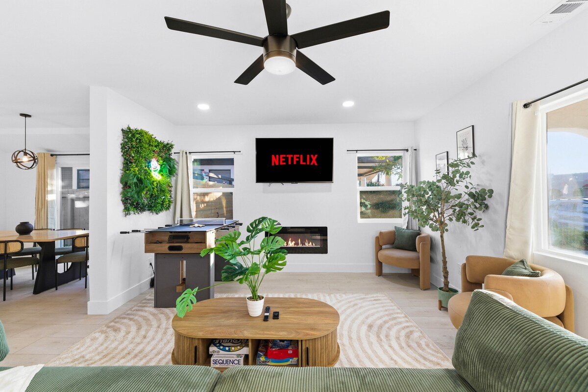 Bekvämt vardagsrum med smart-tv med streaming-appar, centraliserad AC, en mysig fjärrstyrd öppen spis, ett multispelbord med pingis och air hockey och brädspel för familjevänligt nöje.