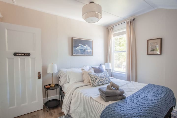 Bluenose Room: cozy queen bed, warm lighting, and of course a river view