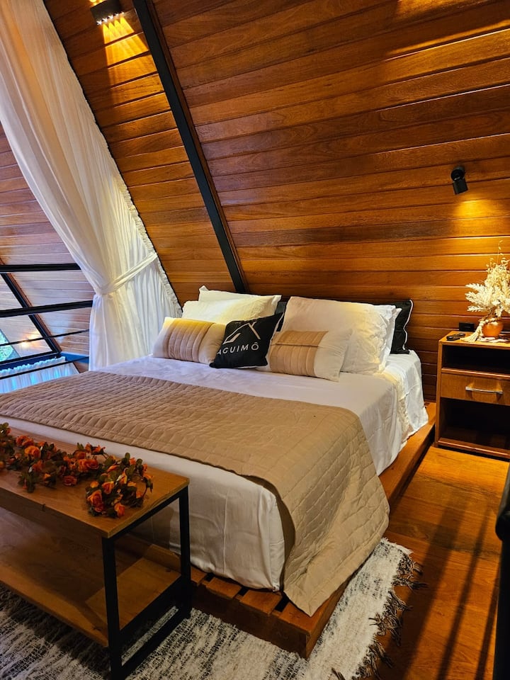 Table, outlets and light at the head of the bed.