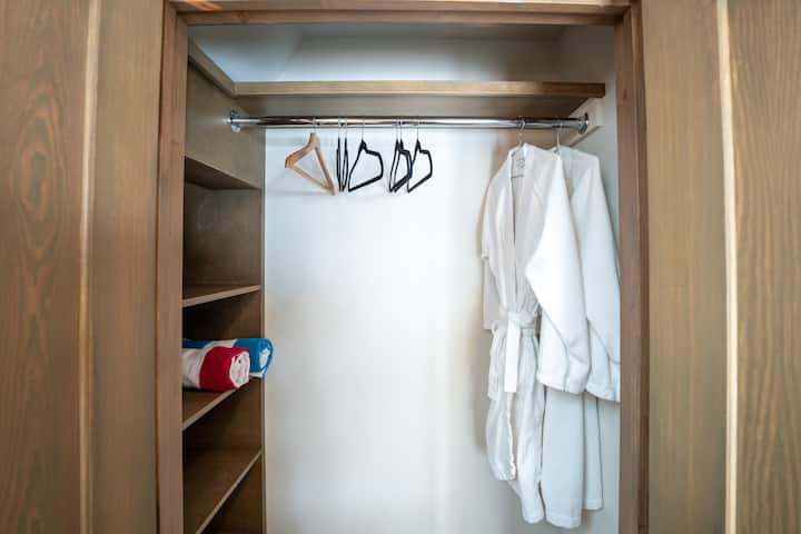 Closet with robes & hot tub outdoor towel.