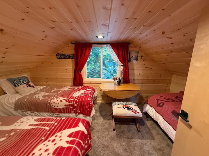 Roshani iliyo na vitanda 3 vya mtu mmoja. Meza na kiti. Kuna kabati dogo lenye rafu na viango kwenye ukumbi. 