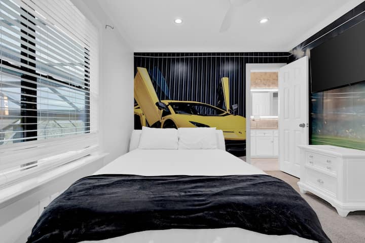 Themed bedroom, featuring a striking sports car mural, sleek white furniture, and a modern, energetic atmosphere,