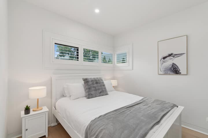 Retreat to a ground-floor primary bedroom, set with a queen bed.