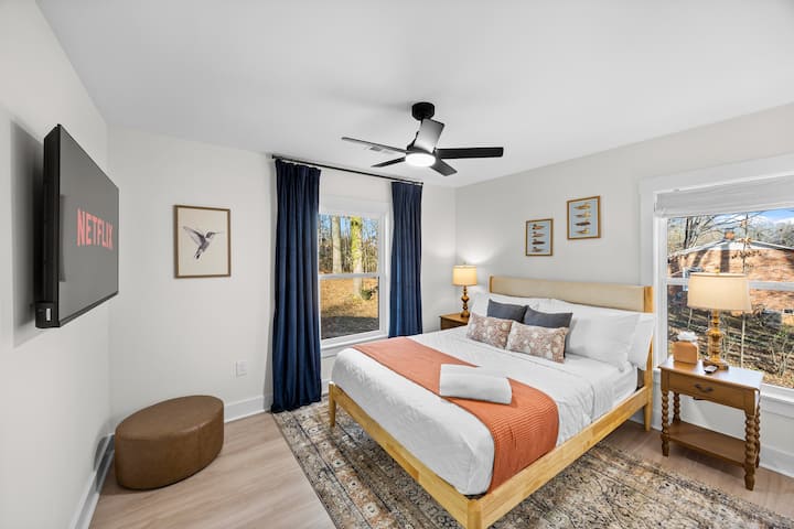 Main floor bedroom with luxury hybrid queen bed, linens and pillows.