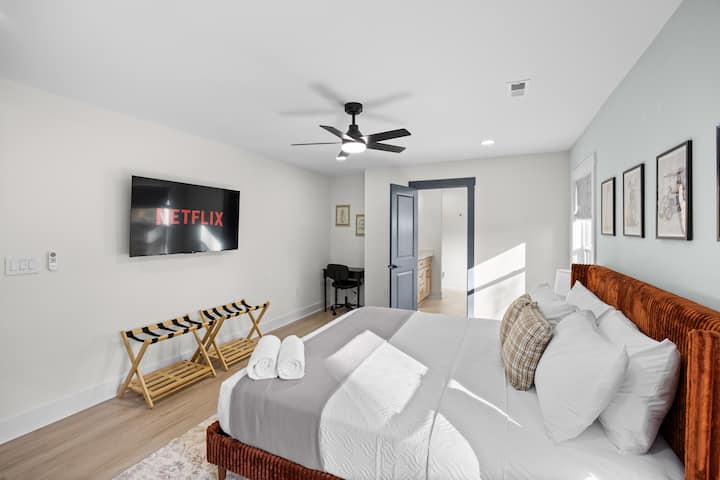 Main floor Primary Bedroom with 55" 4K Smart TV and dedicated work space