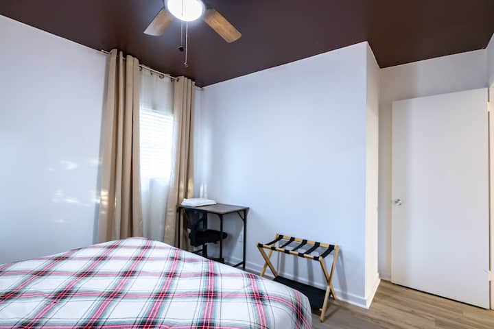 Des rideaux occultants et un ventilateur au plafond sont présents dans la chambre. 