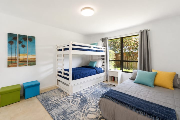 Dedicated bunk room designed for kids or teens, offering comfortable built-in sleeping and extra storage.