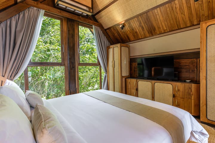 Upstairs bedroom that includes a hidden TV with Netflix, Prime and other channels available.   There is a workspace directly outside the bedroom.  The upstairs also has a balcony that provides the best views of Buyan lake and Handara Golf Course.