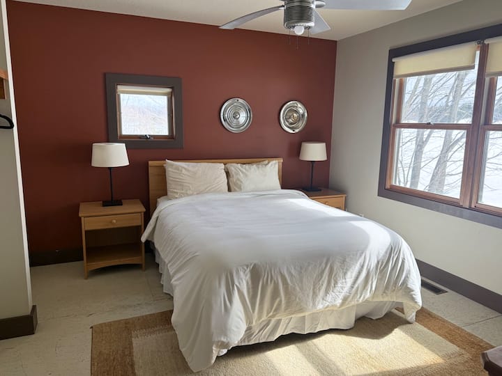 Main level spacious bedroom with a queen size bed