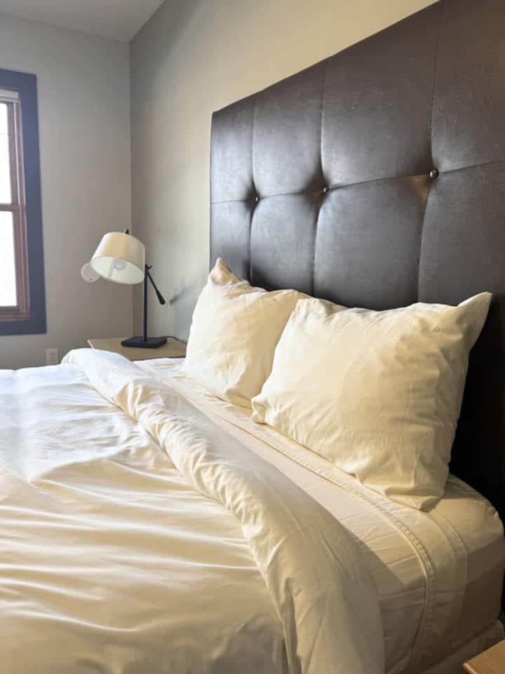 Downstairs bedroom with a queen size bed