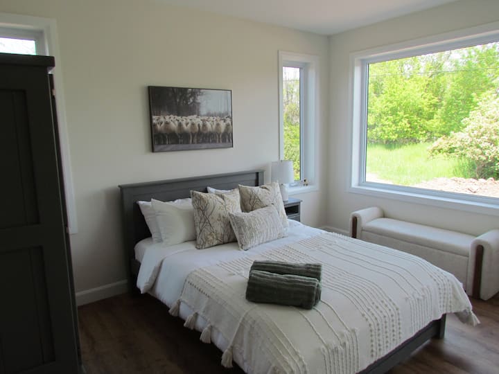 Queen sized bed with Endy mattress and bedding. Enjoy the expansive views of neighbouring pastures - our friends and neighbours Topsy Farms occasionally graze their sheep in the field.