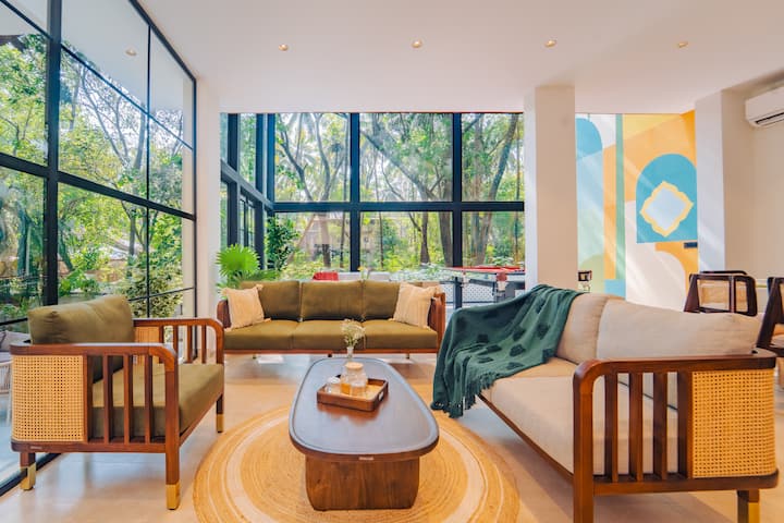 A serene 5BHK glass house amid lush Goan greenery