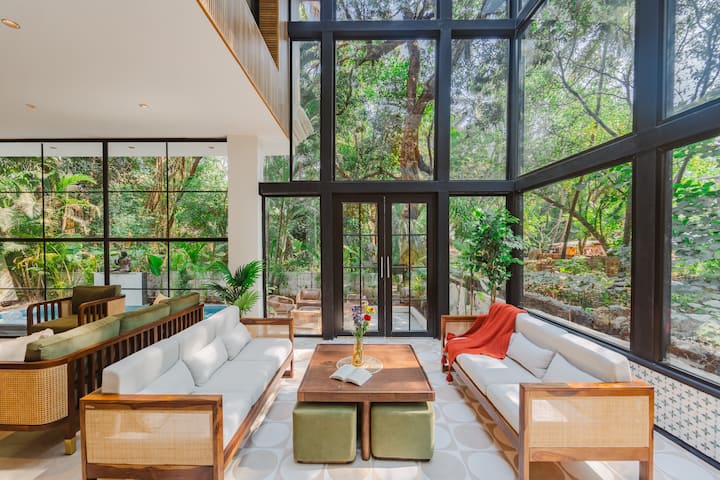 A serene 5BHK glass house amid lush Goan greenery