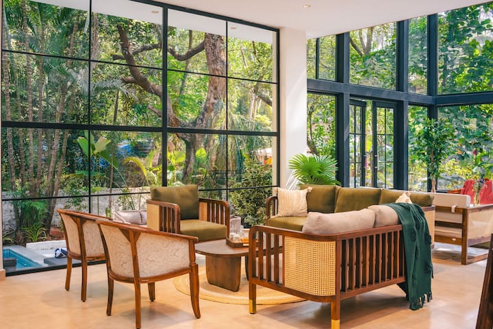 A serene 5BHK glass house amid lush Goan greenery