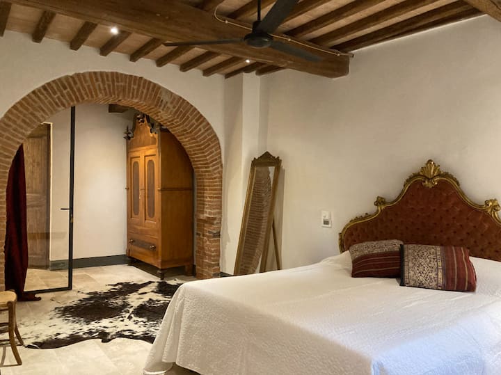 The bed is a large Queen, Italian size 170cm x 200cm. The bedrooms feature glass walls for light and openness, with full curtains that close for complete privacy when sleeping.