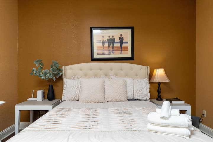 Cozy and inviting bedroom featuring a tufted headboard and warm, earthy tones.