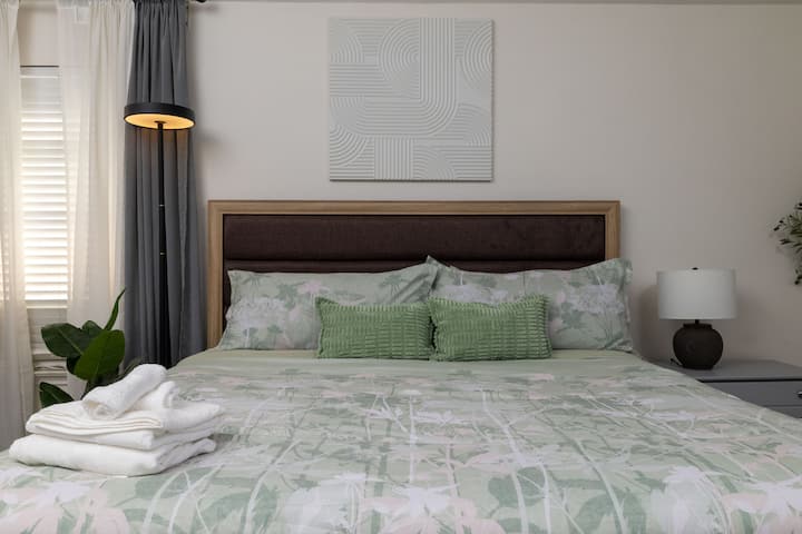 Cozy bedroom with a king bed and nature-inspired decor.