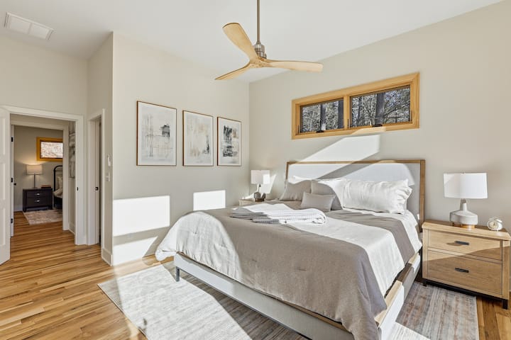 Retreat to this peaceful bedroom filled with soft light and forest views. The cozy bed and calming tones create the perfect place to unwind, sleep deeply, and wake refreshed.