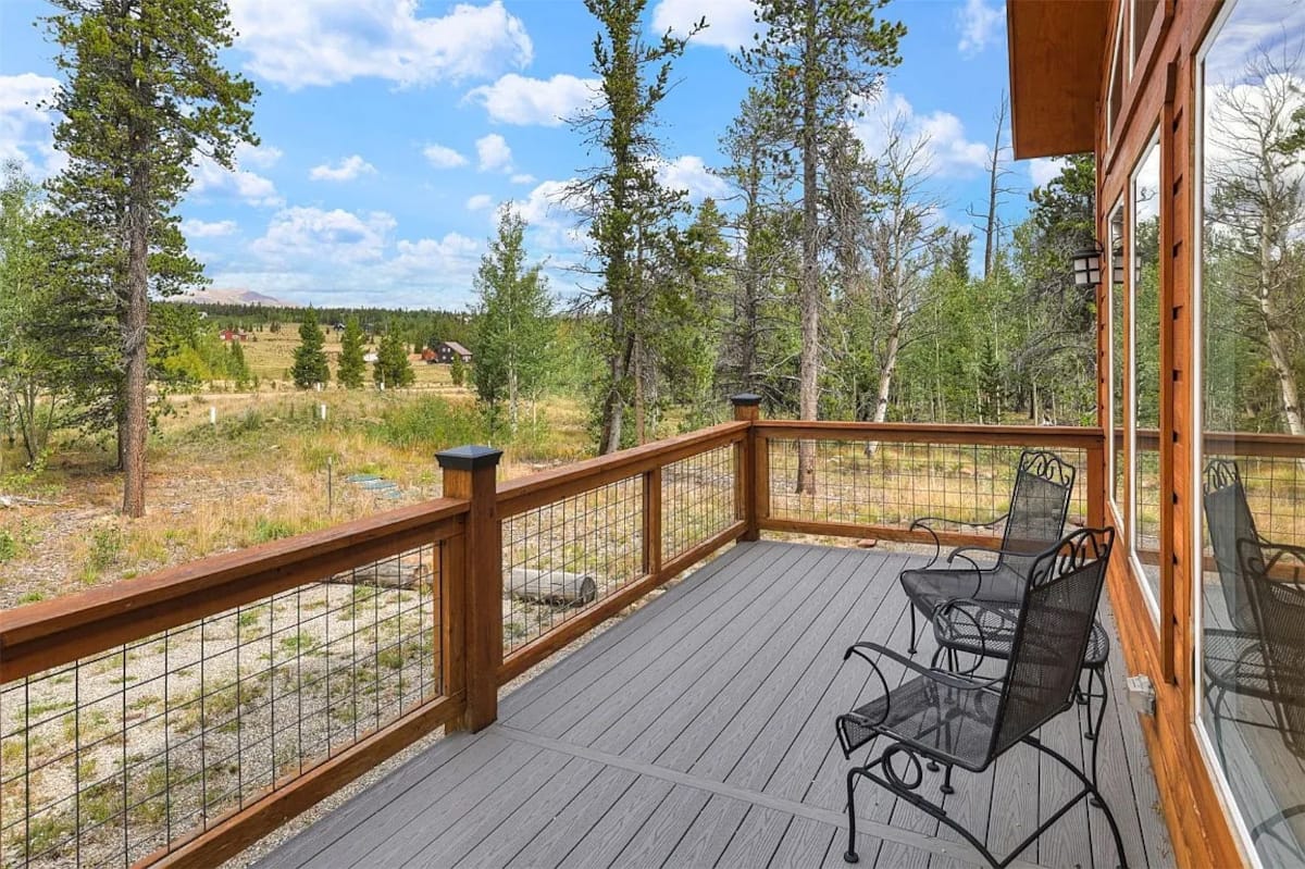 Private deck with chairs and wooded views
