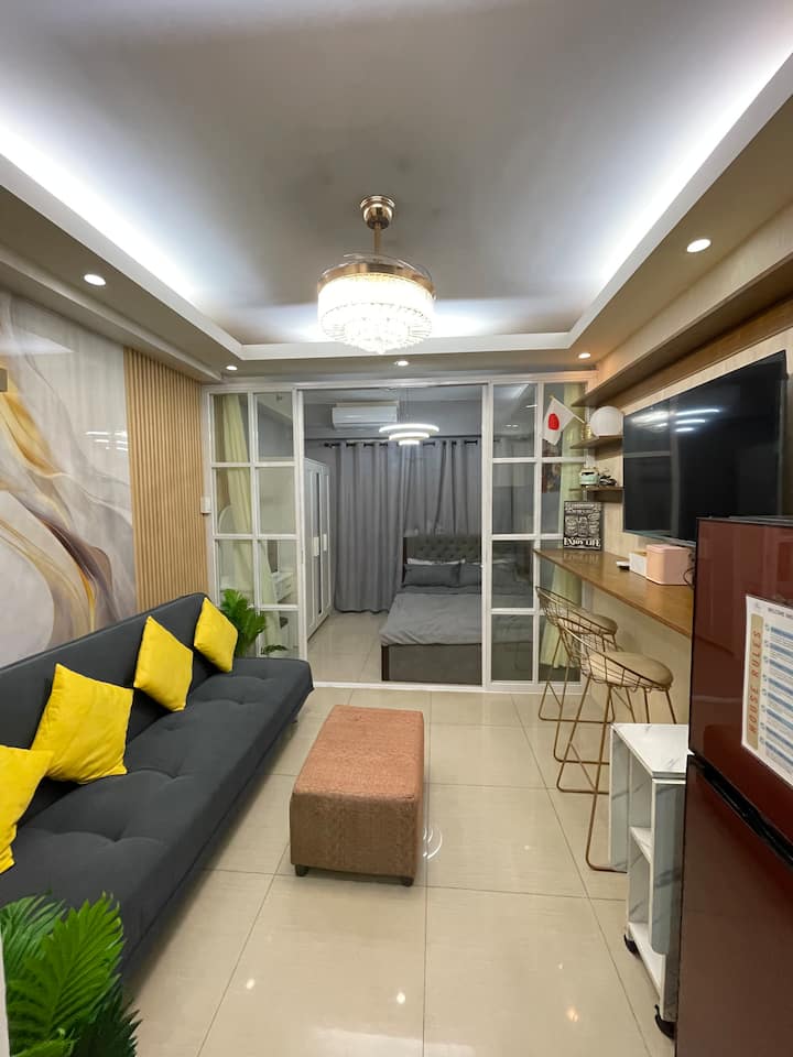 Livingroom with Couch, convertible into a sofa-bed that can sleep 2 people. 55 Inches Smart TV with Free Netflix. Foldable dining table for feasting.