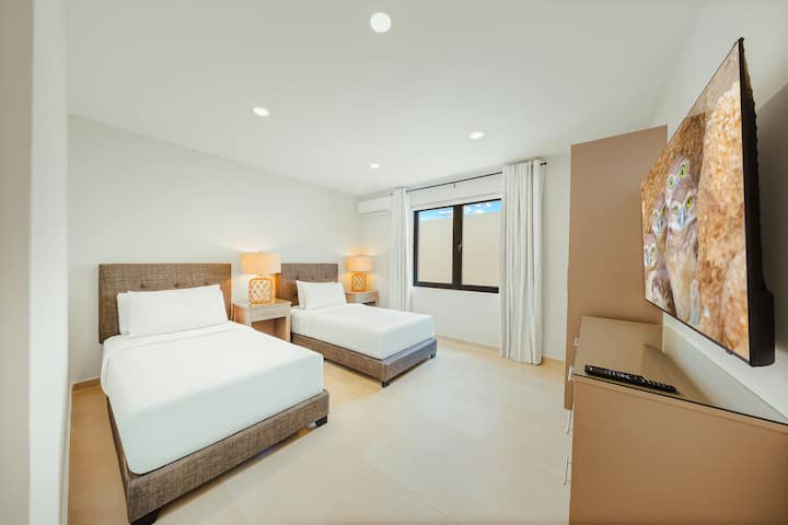 Bedroom 4 with ensuite, large closet, dresser and 55" TV