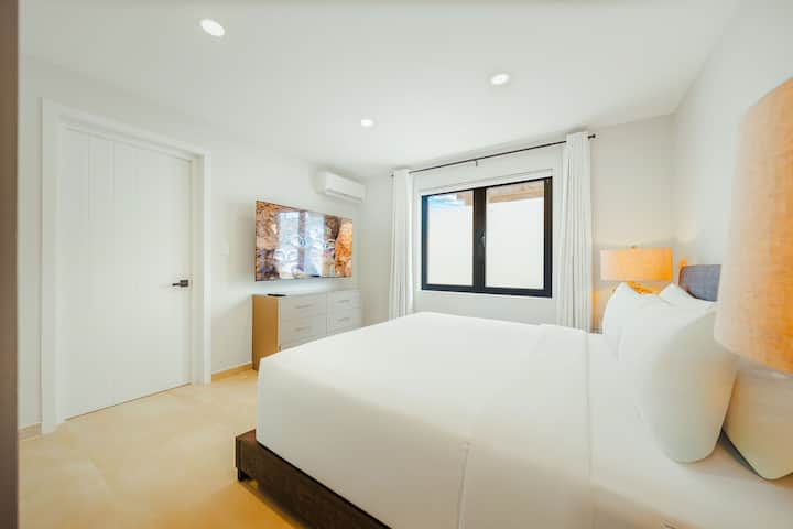 Bedroom 3 with ensuite, large closet, dresser and 55" TV