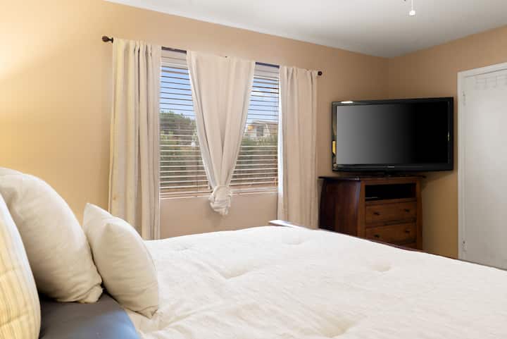 The master bedroom features a TV for entertainment and offers a perfect blend of comfort and design. With plush bedding, elegant pillows, and tasteful decor, you will sleep like a baby.