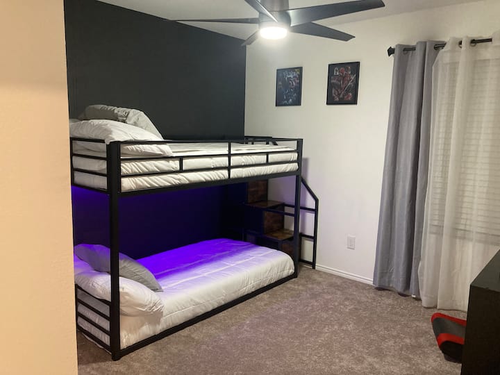Esta habitación cuenta con literas de dos camas individuales de perfil bajo con escalones y almacenamiento, luces LED con controles remotos, edredón de lujo de algodón 100% orgánico y un televisor inteligente, juegos familiares listos para la noche de juegos en familia.