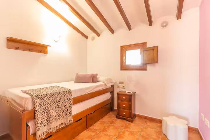 Dormitorio 4 con cama individual, mesilla y ventana: rincón tranquilo para descansar.