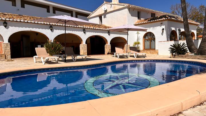 Gran piscina privada con solárium y la villa al fondo: espacio de sobra para todo el grupo.
