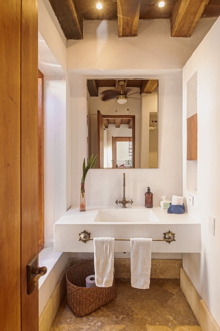 En-suite bathroom with wood beam ceiling