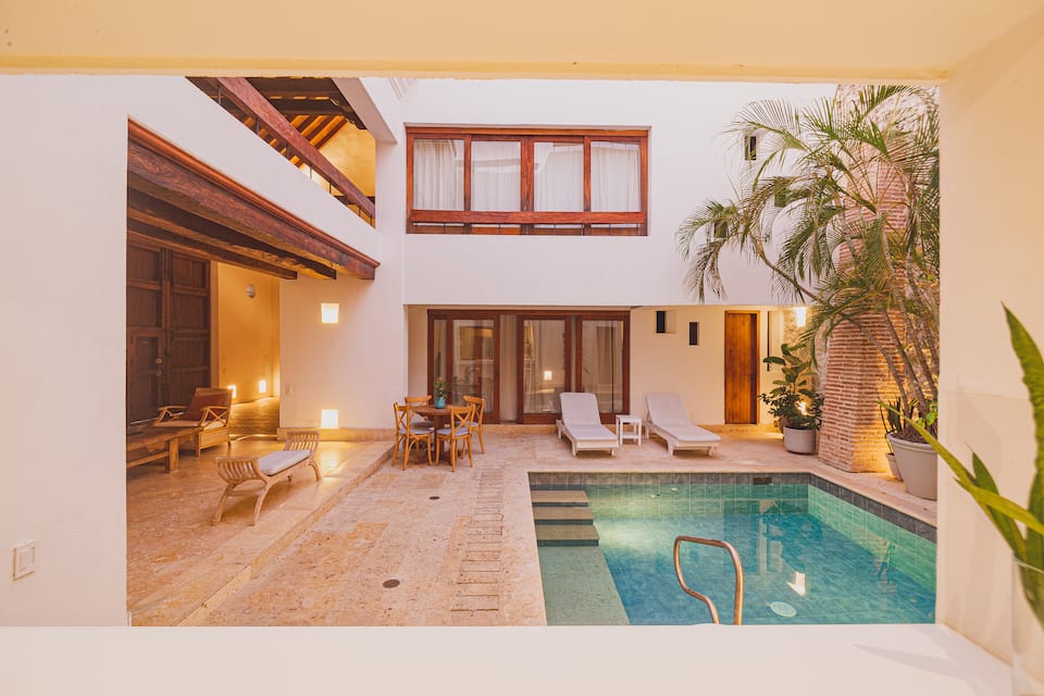 Courtyard pool and stone wall at night