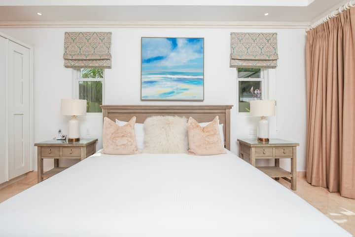 Spacious master bedroom two with en suite, air conditioning, ceiling fan, smart TV, wardrobe, security safe, rain shower head, twin vanity unit, hair dryer and walk in shower.