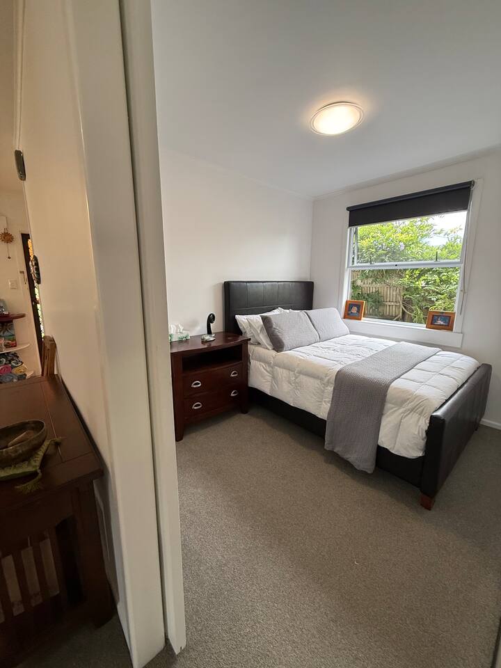 Queen size bed. Firm top quality Tempurpedic mattress. Down duvet. Variety of pillows to suit your preference. Bedside table. Open plan closet with plenty of shelving and ample hangers. Blackout roller blind. 