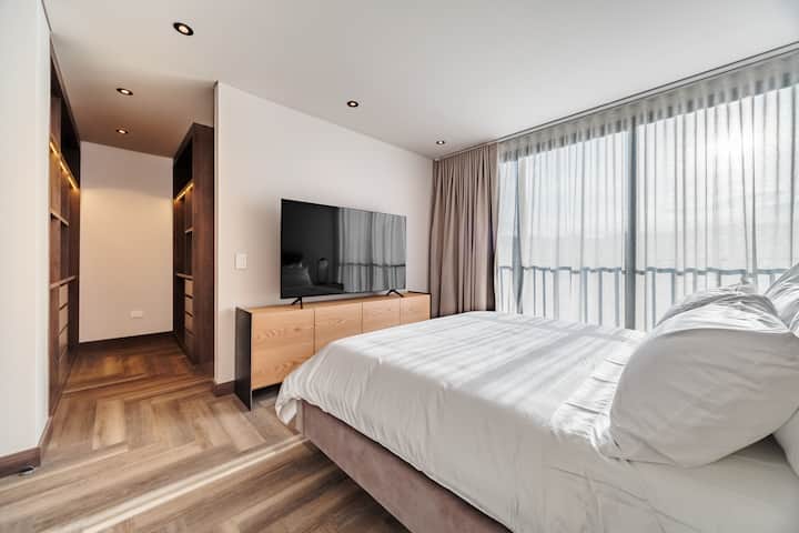 Bright and airy bedroom with a Queenbed, scenic views, and plenty of sunlight. Spacious and stylish, featuring a TV for your comfort and entertainment.