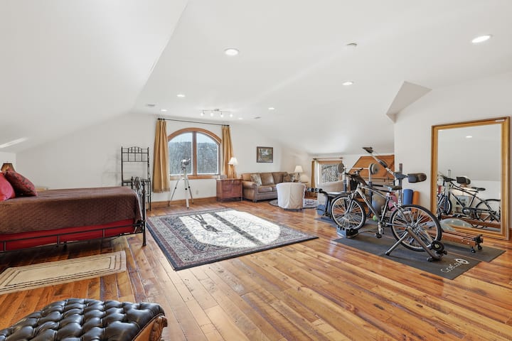 This upper-level bedroom blends comfort with charm, offering a quiet place to rest after busy days together. The warm wood floors add a cozy lodge feel.