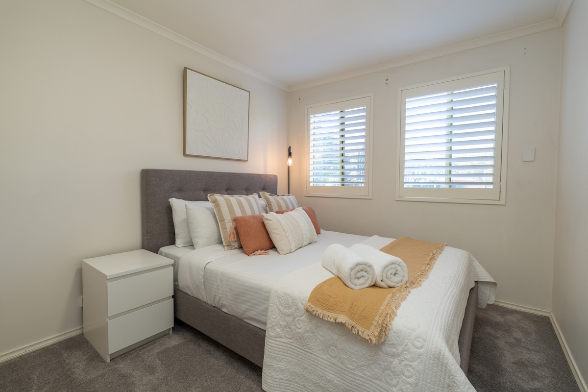 Our well-proportioned master bedroom with soft tones and filtered daylight through plantation shutters. The layout leaves room to move, making it easy to settle in, unpack and enjoy a comfortable night’s rest.