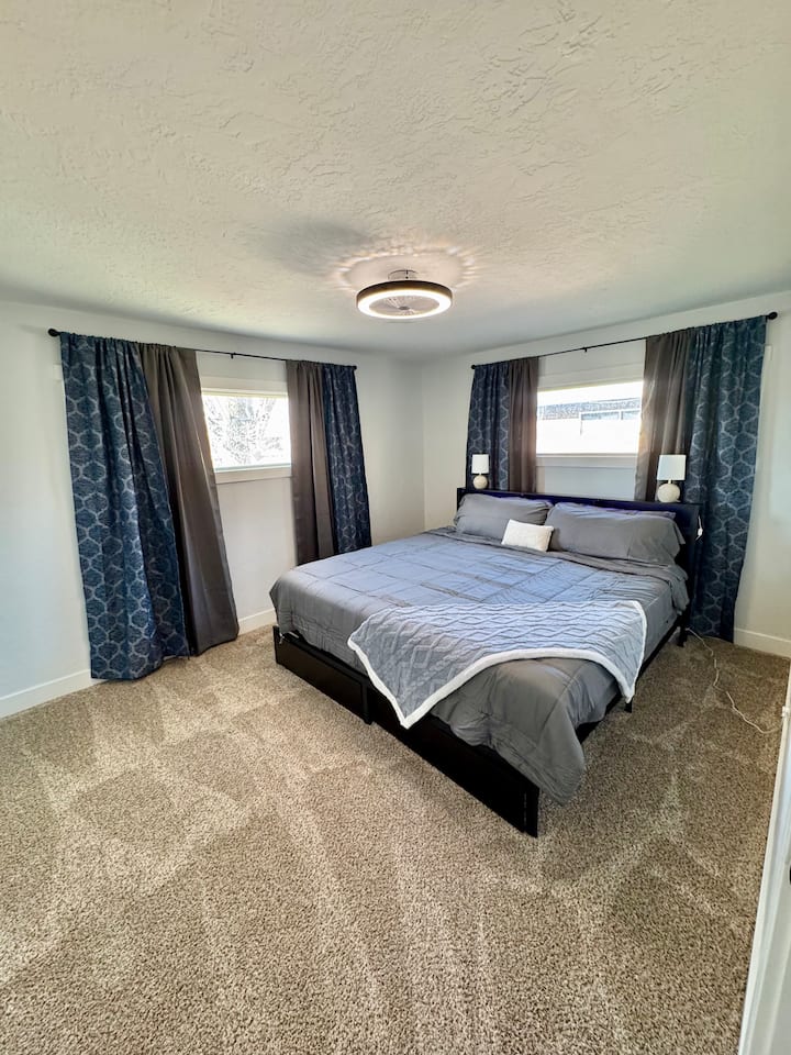 მთავარი ლუქსი საწოლით 193×203 სმ და გაშლილი ფარდებით