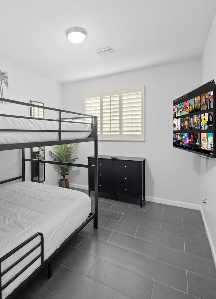 2nd Middle Bedroom with queen bunk beds, smart TV, dresser, full-length mirror, fan, closet with luggage racks