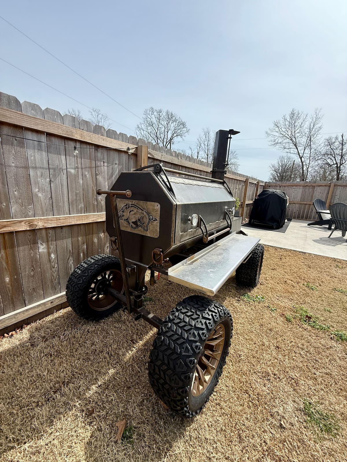 Custom offset smoker fired up in the backyard