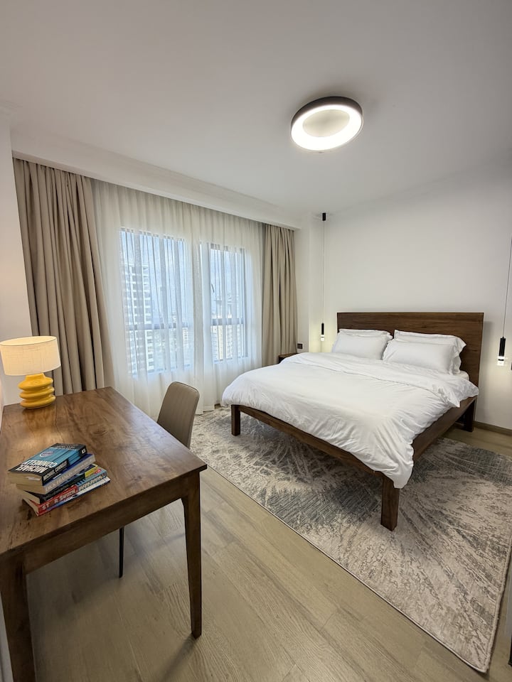Comfortable bedroom with a plush bed, fresh linens, ample storage, a bright relaxing atmosphere and a dedicated workspace, giving you the flexibility to relax, catch up on work, or work remotely during your stay.