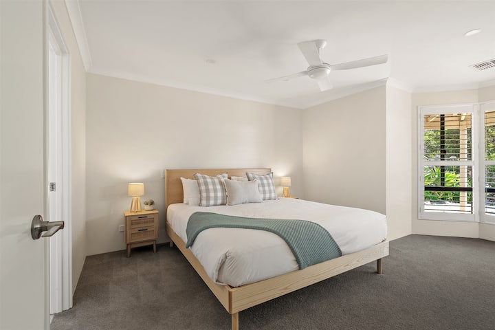 Amka ukiwa na mwanga laini wa asili katika chumba kikuu cha kulala, ambapo kitanda aina ya king, chumba cha kulala na robi ya kuvaa huunda mapumziko ya amani kwa asubuhi za polepole.