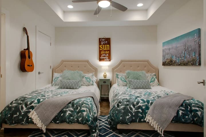 Step into this bright and charming first-floor bedroom, featuring two full beds and a convenient half bath, making it a perfect, cozy retreat in your new home.