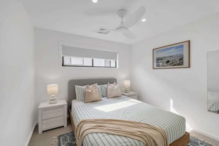 This bedroom features a comfortable queen-sized bed and a large wardrobe, with quality linen and towels provided for your stay.