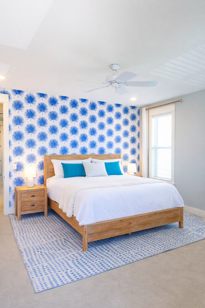 "The Blue Palm" room; stylish king suite with coastal detail and a calm, restful feel.